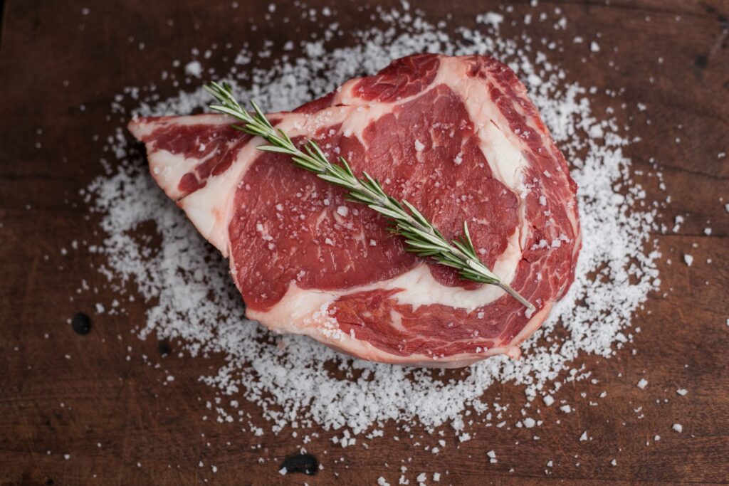 raw meat on brown wooden table