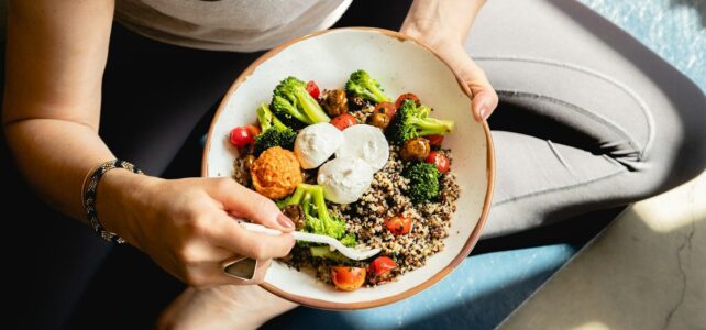 Why Wellness Is Becoming the New Ingredient in Everyday Living a woman is holding a bowl of food